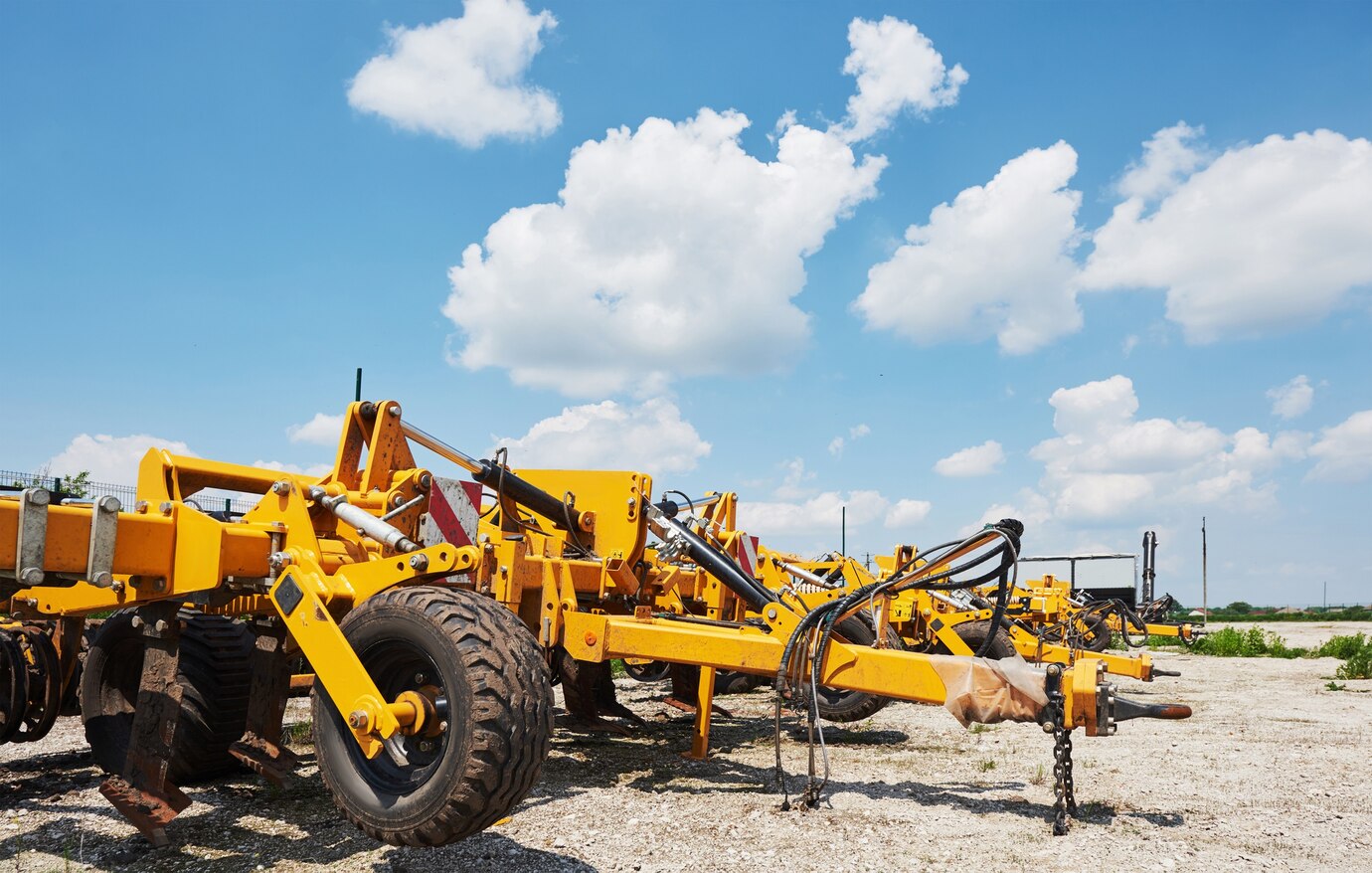 close-up-seeder-attached-tractor-field_146671-19092